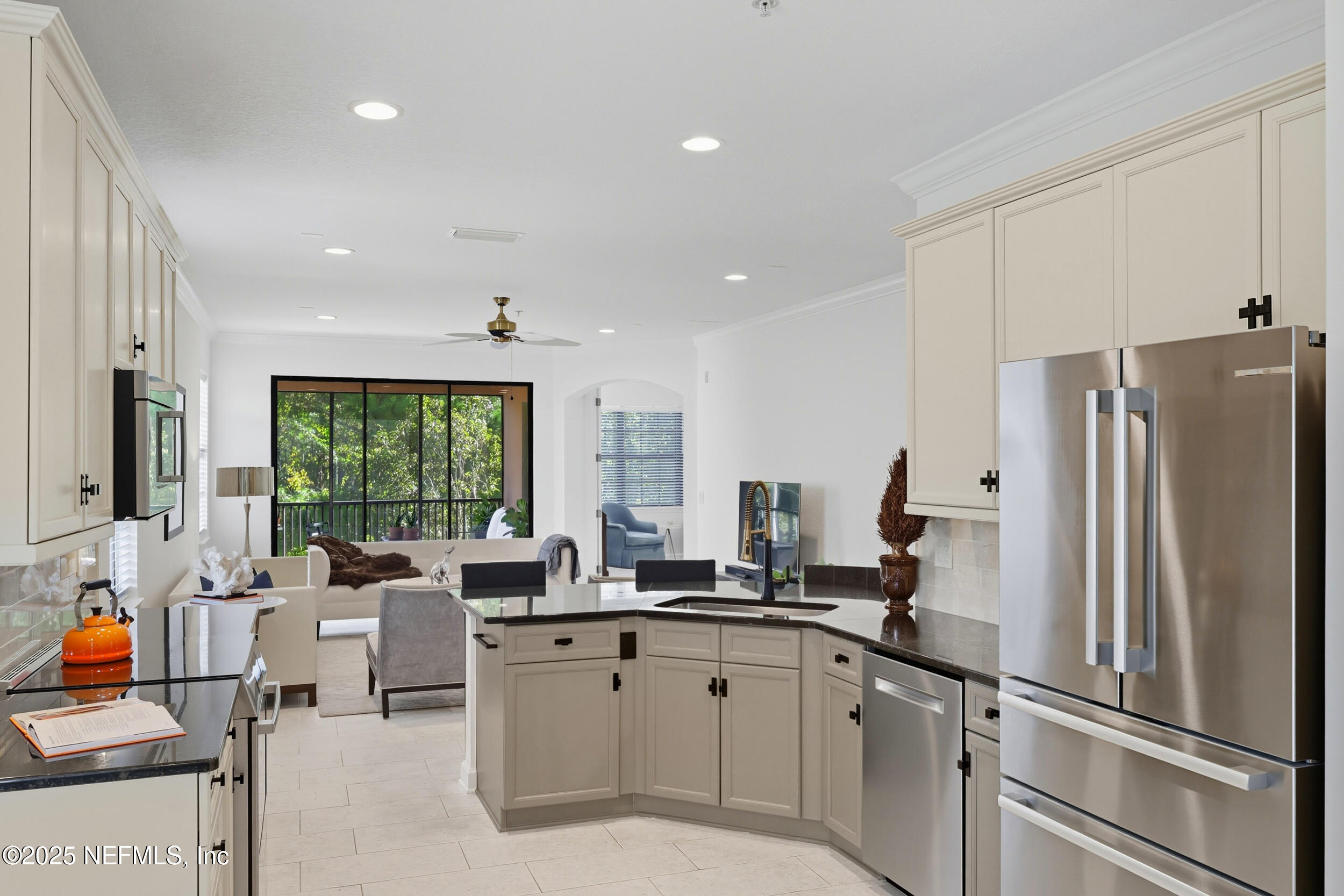 210 Paseo Terraza, Unit 301 St. Augustine, FL 32095 - Photo 19 of 54 a kitchen with stainless steel appliances granite countertop a refrigerator and a sink