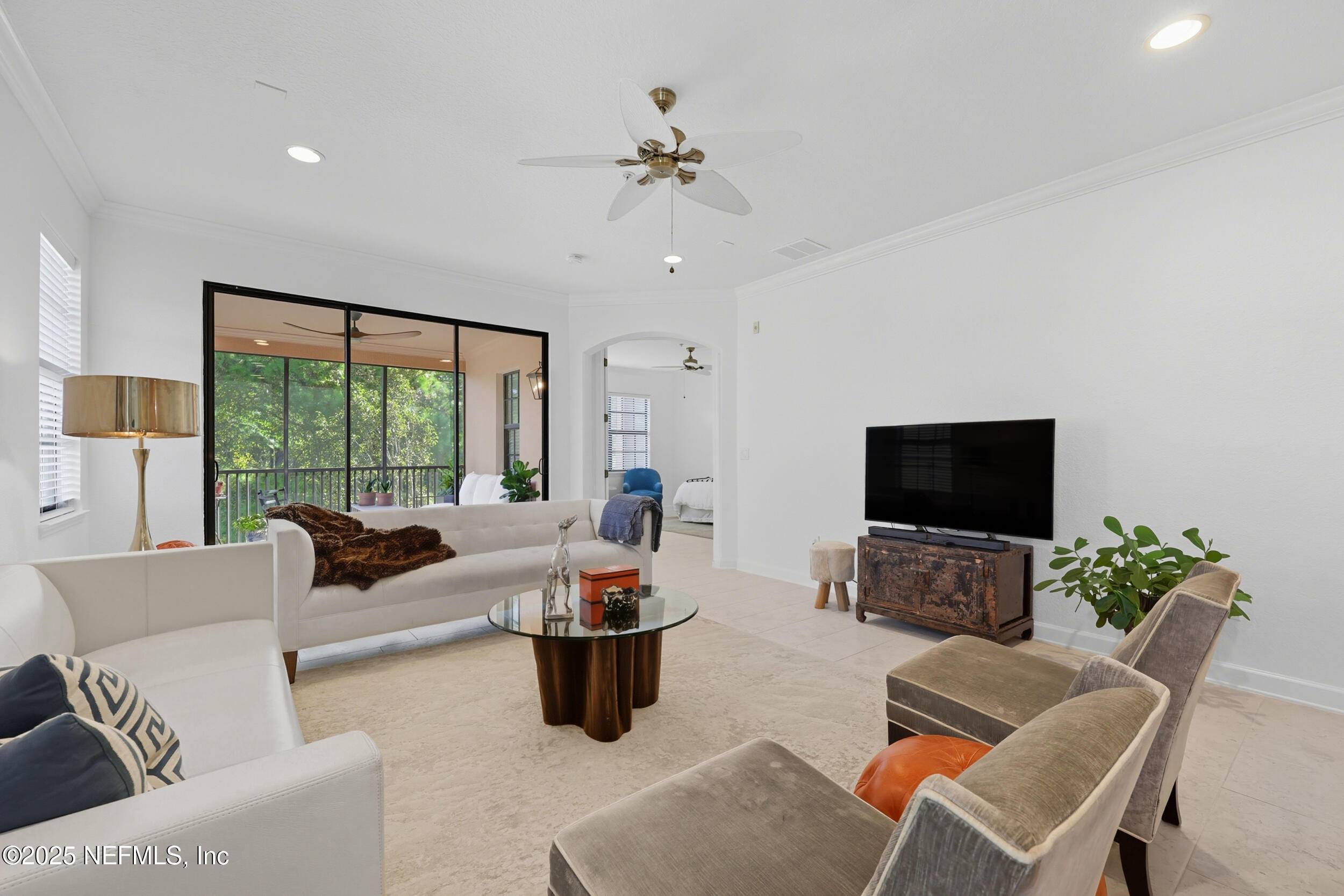 210 Paseo Terraza, Unit 301 St. Augustine, FL 32095 - Photo 20 of 54 a living room with furniture a flat screen tv and a large window