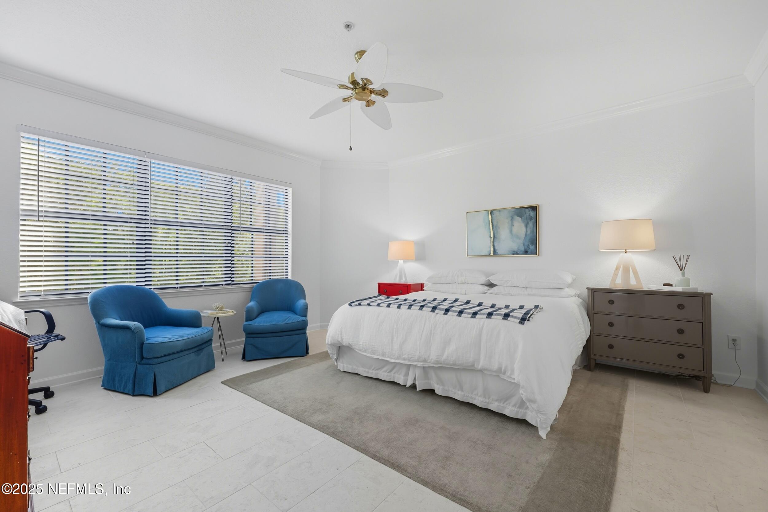 210 Paseo Terraza, Unit 301 St. Augustine, FL 32095 - Photo 23 of 54 a spacious bedroom with a bed and a couch