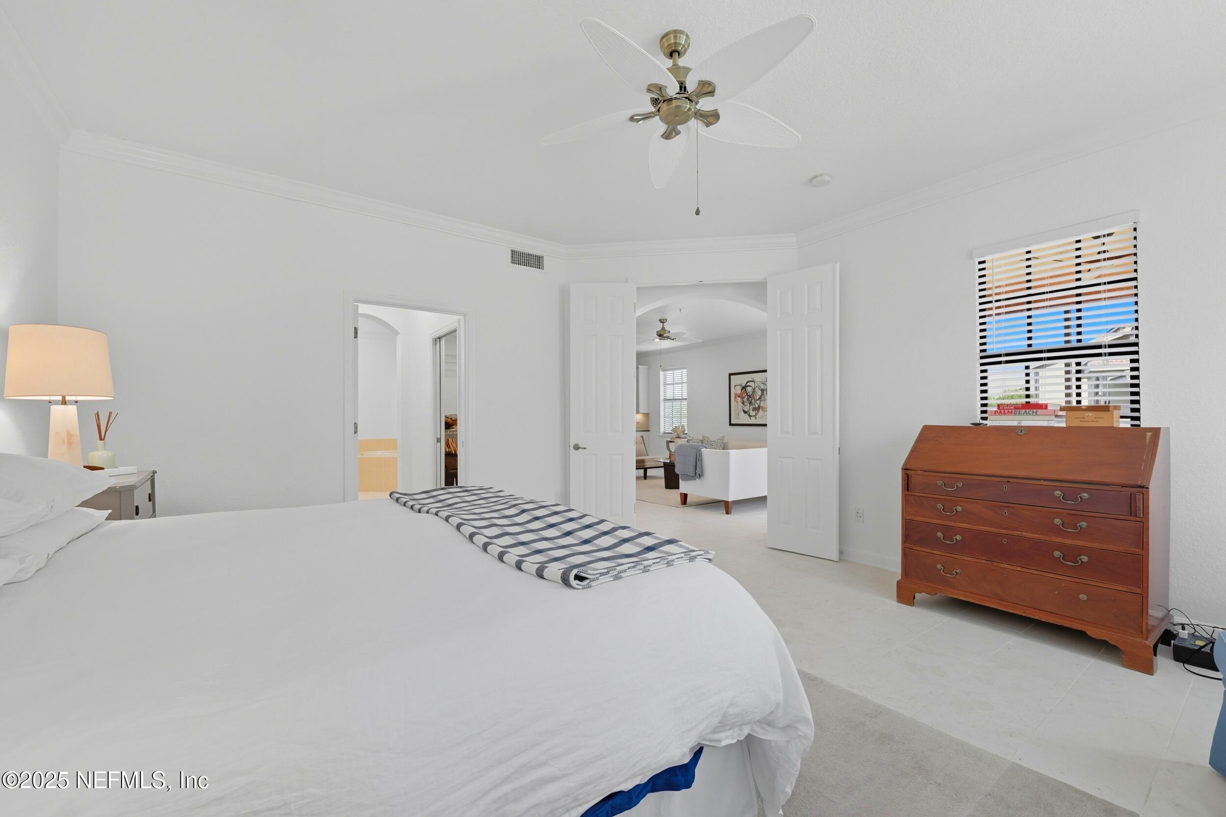 210 Paseo Terraza, Unit 301 St. Augustine, FL 32095 - Photo 24 of 54 a bedroom with a bed and dresser