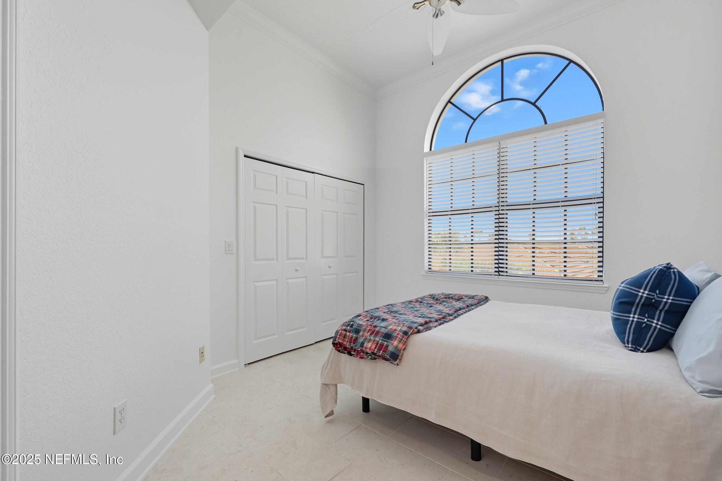 210 Paseo Terraza, Unit 301 St. Augustine, FL 32095 - Photo 26 of 54 a bedroom with a bed and a window