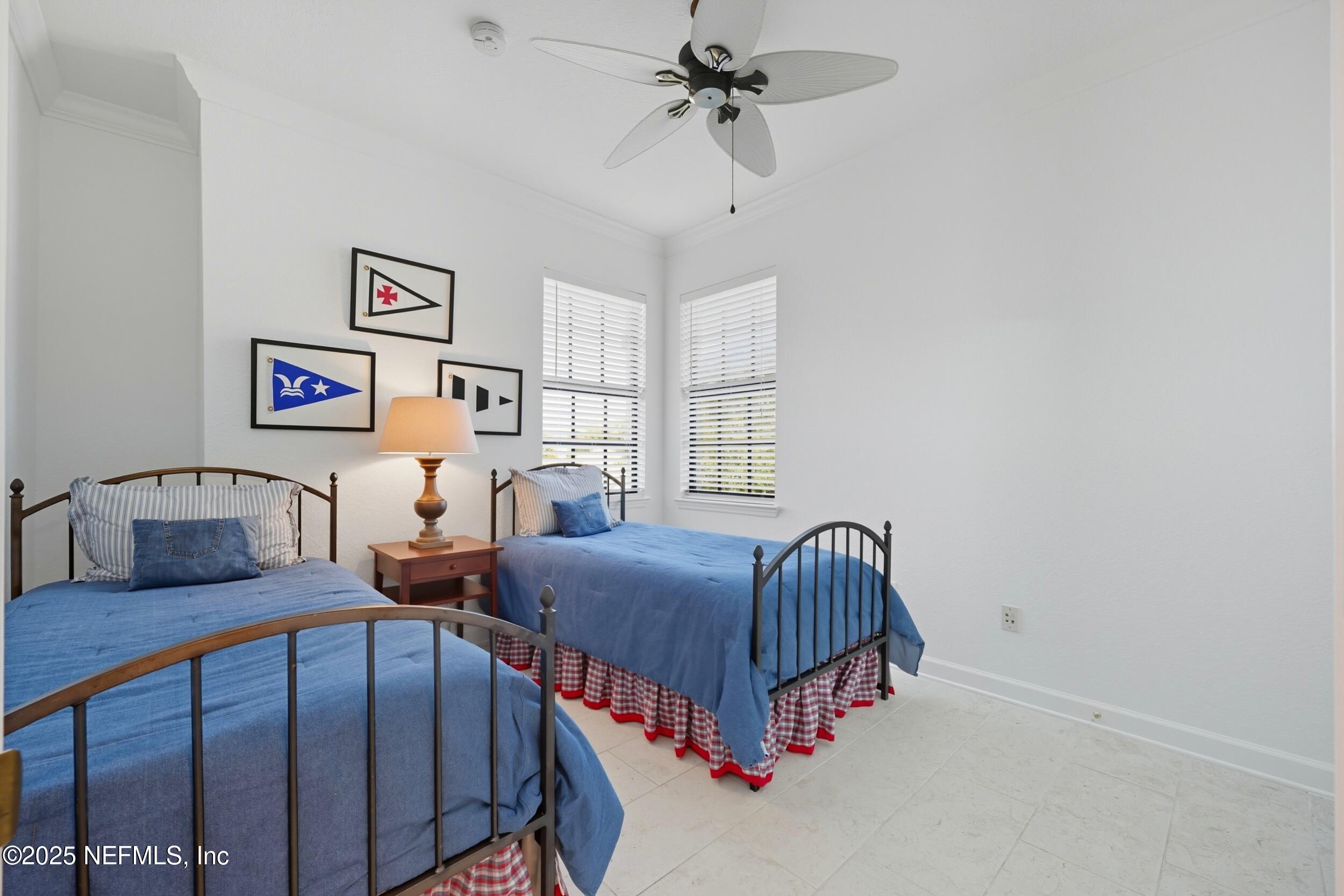 210 Paseo Terraza, Unit 301 St. Augustine, FL 32095 - Photo 28 of 54 a bedroom with two beds and a window