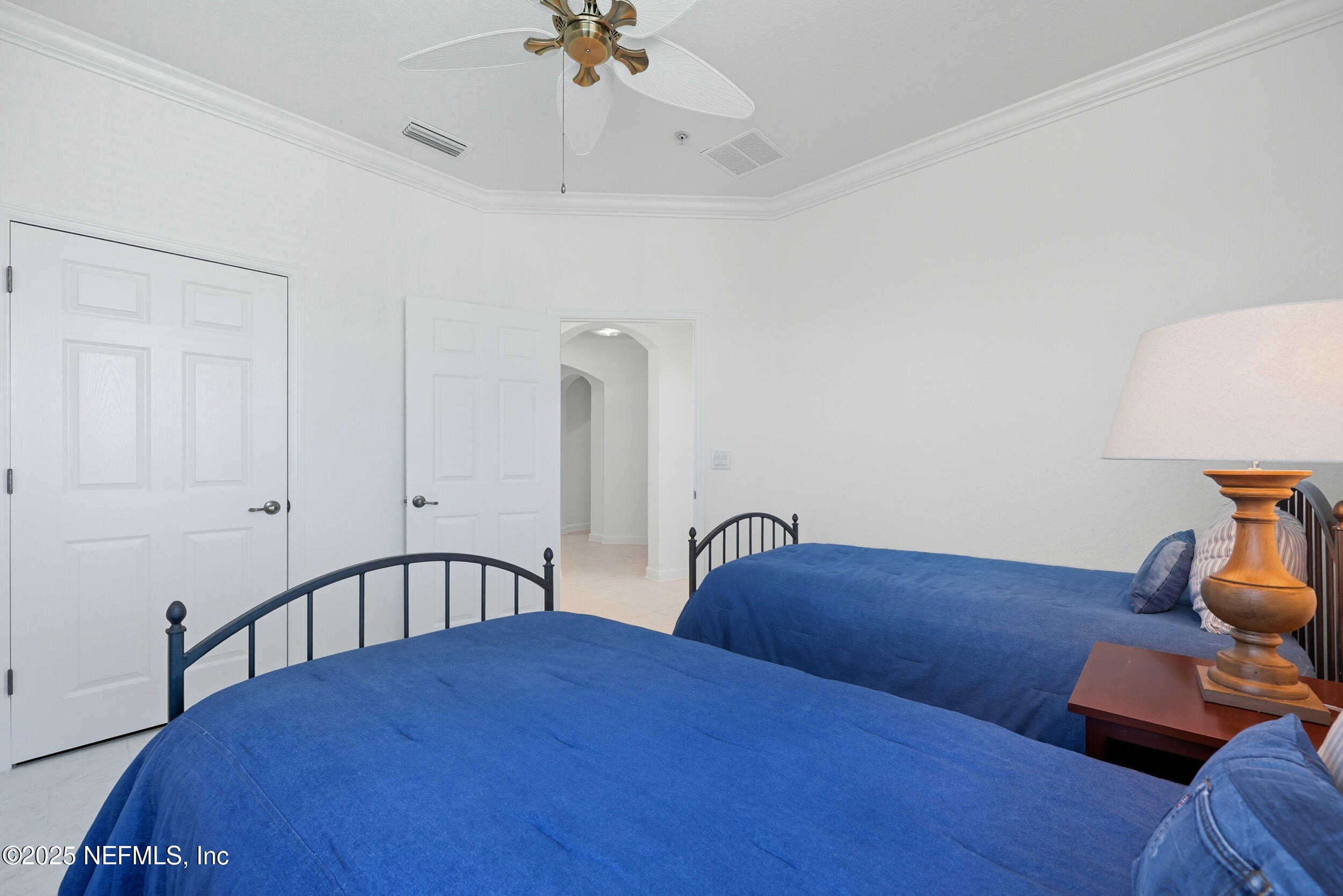210 Paseo Terraza, Unit 301 St. Augustine, FL 32095 - Photo 29 of 54 a bedroom with a bed and a chandelier