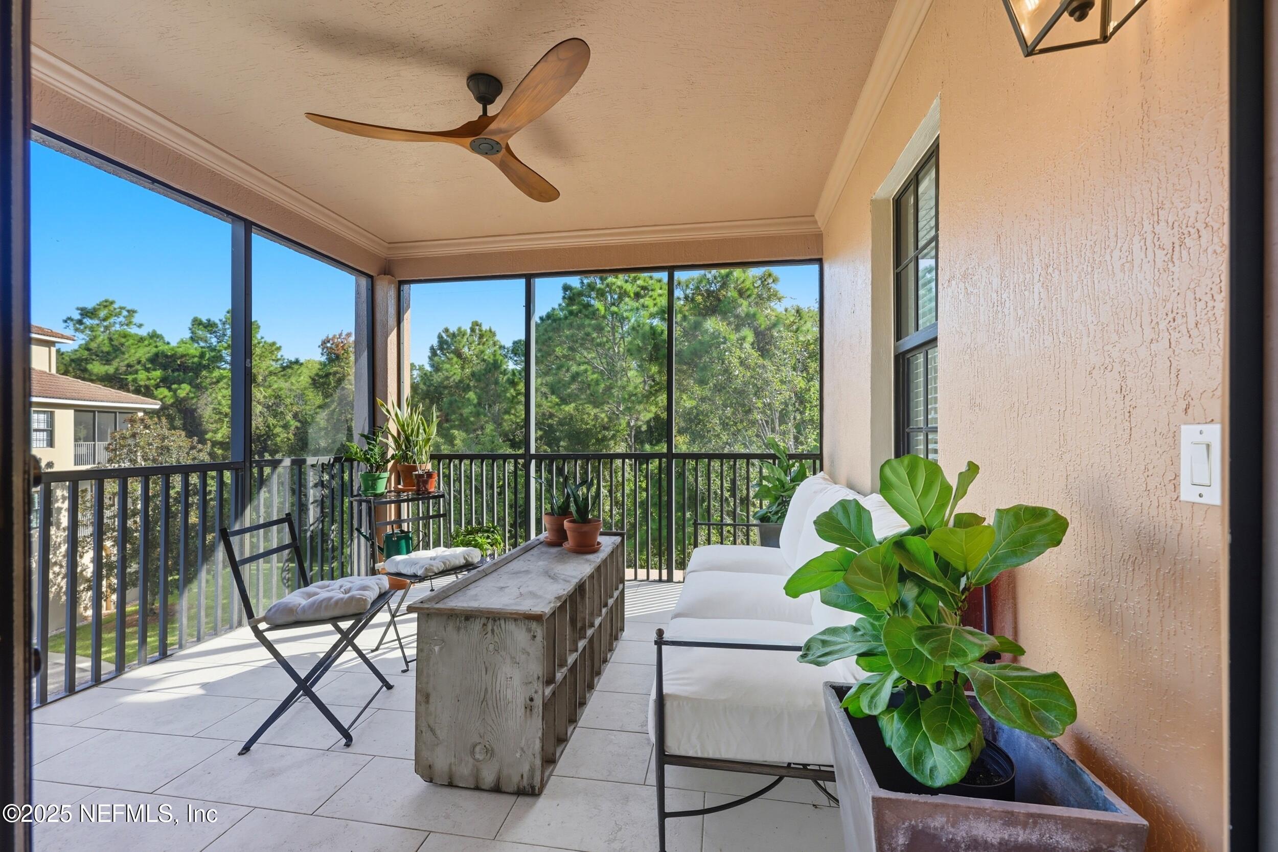 210 Paseo Terraza, Unit 301 St. Augustine, FL 32095 - Photo 31 of 54 a living room with a floor to ceiling window and a potted plant