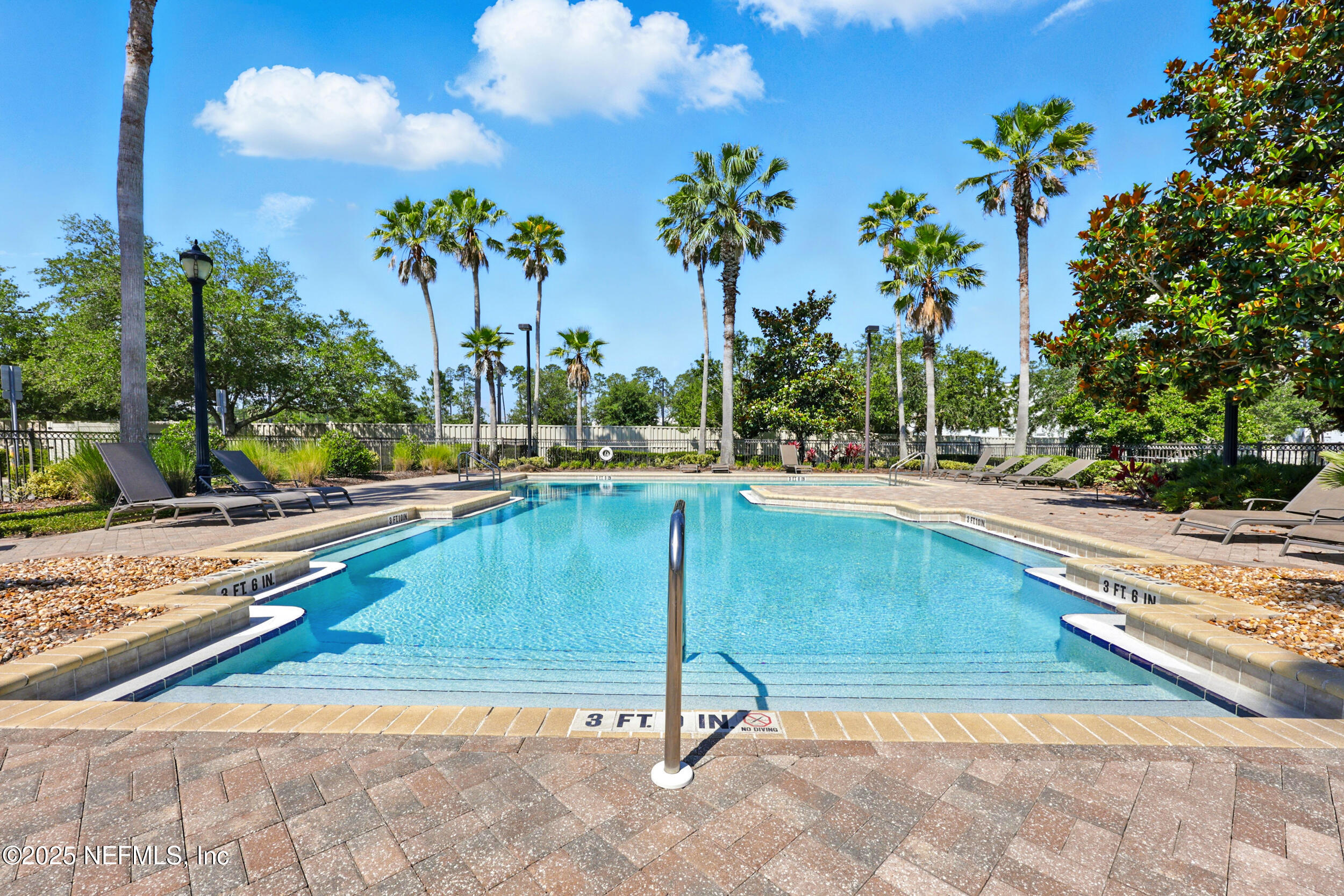 210 Paseo Terraza, Unit 301 St. Augustine, FL 32095 - Photo 37 of 54 a swimming pool with trees in the background