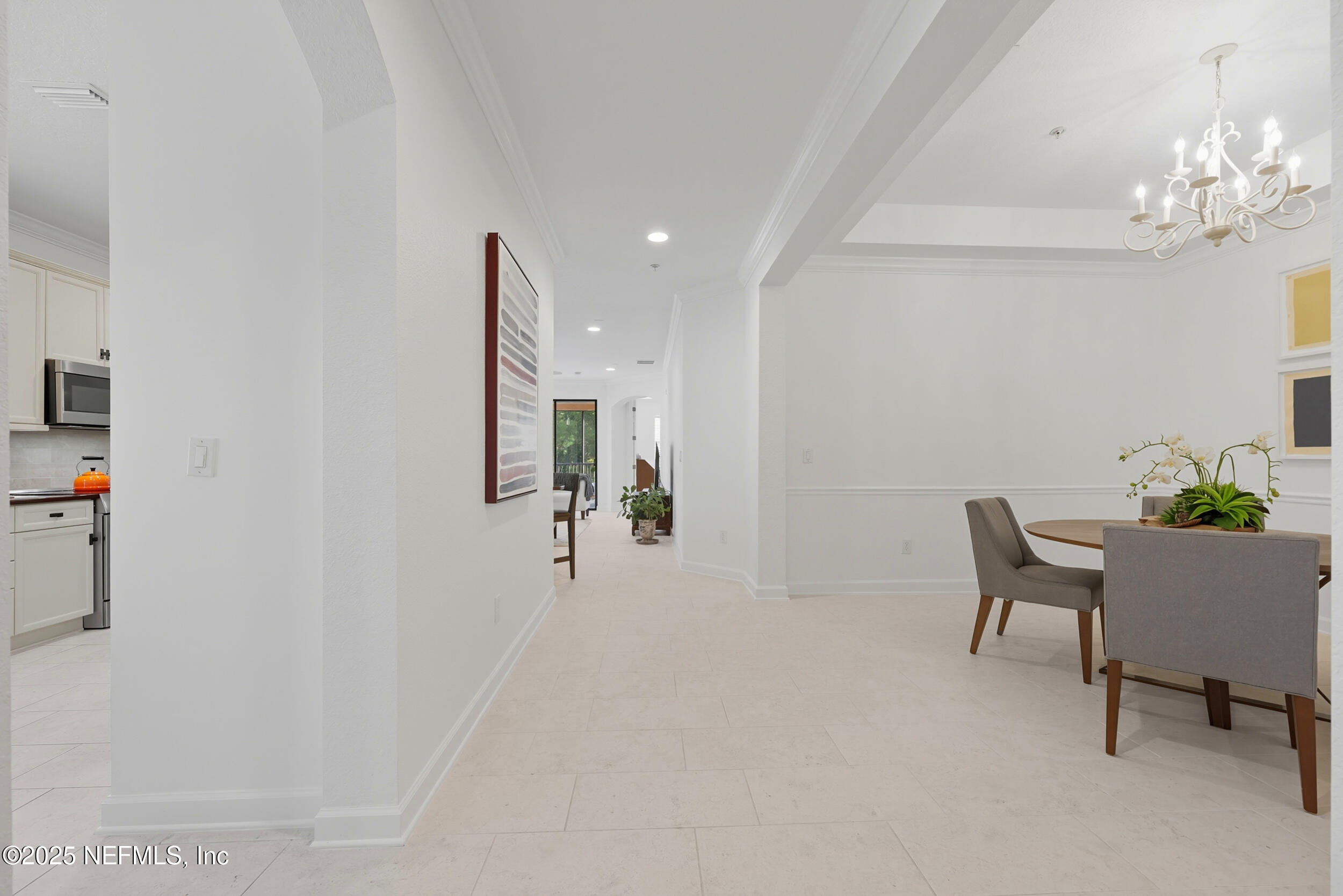 210 Paseo Terraza, Unit 301 St. Augustine, FL 32095 - Photo 10 of 54 a living room with furniture and a chandelier