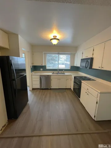 a kitchen with a cabinets and appliances
