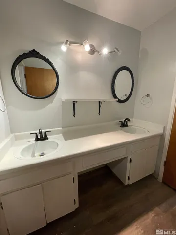 a bathroom with a double vanity sink and a mirror