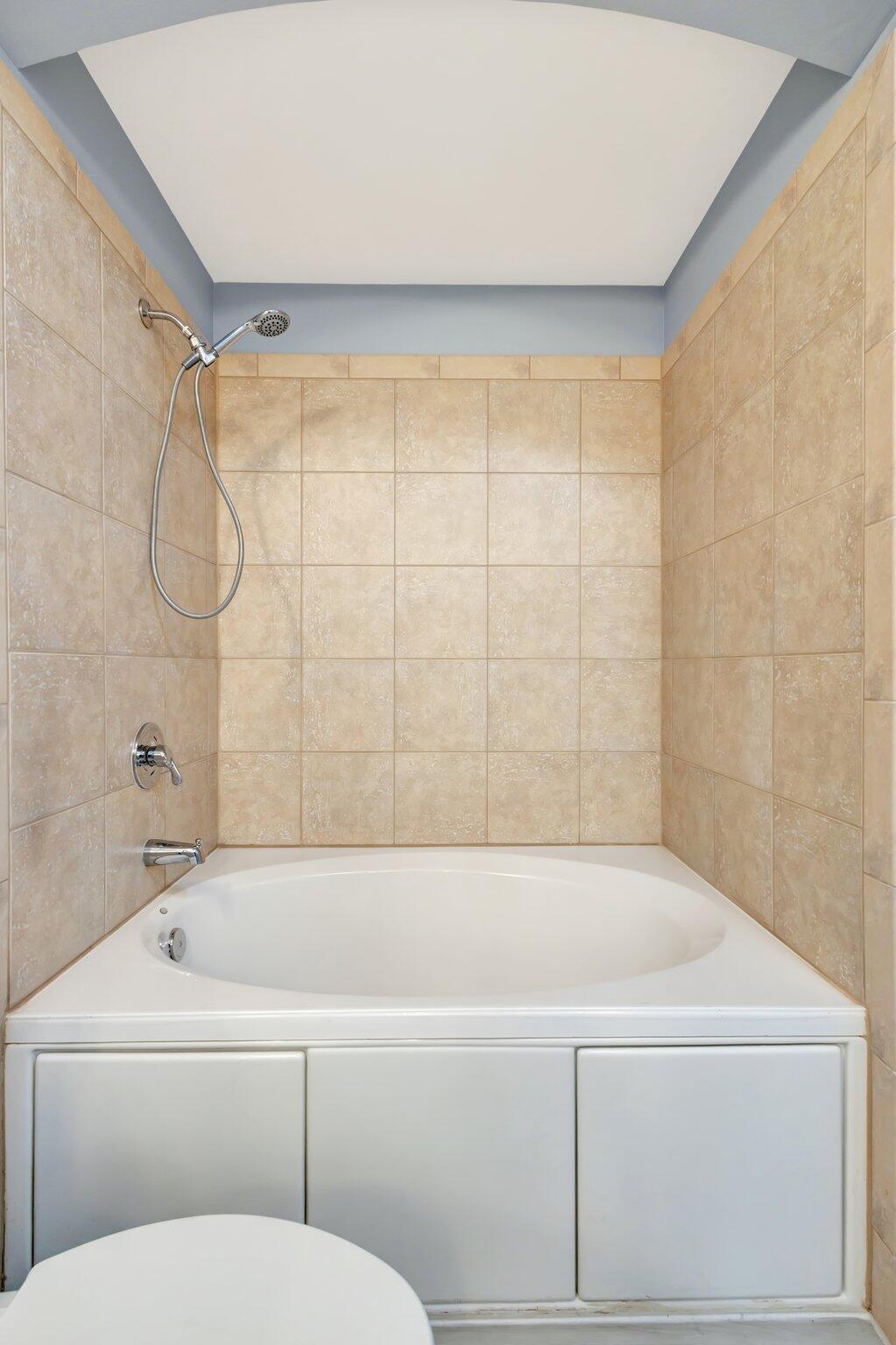 1690 Renaissance Commons Boulevard, Unit 1401 Boynton Beach, FL 33426 - Photo 11 of 41 a bathroom with a bathtub and a shower