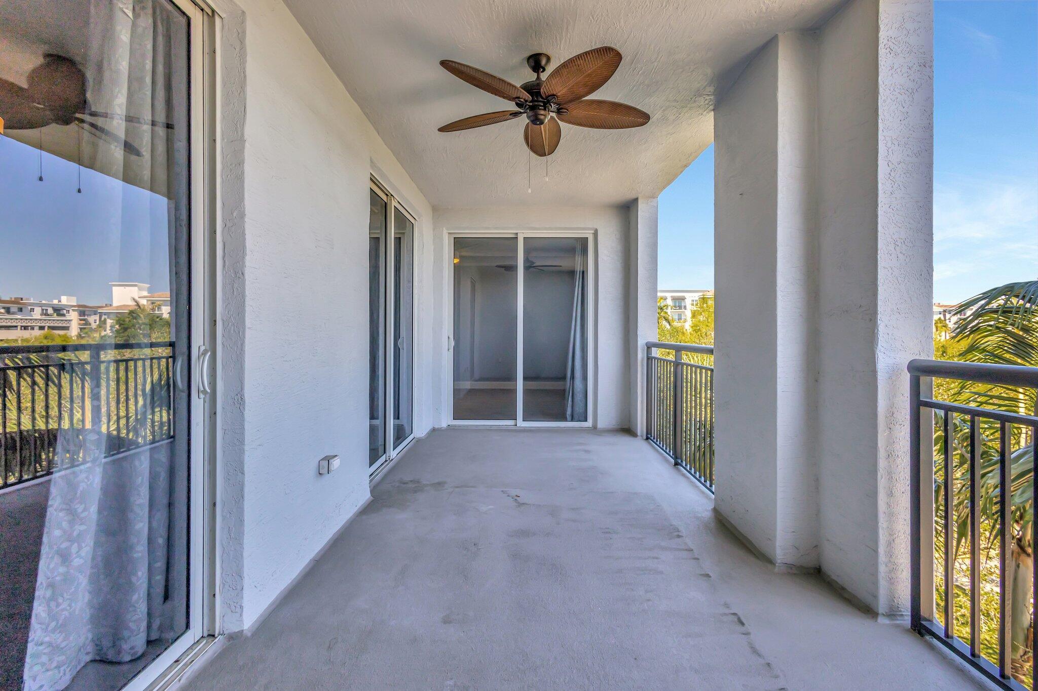 1690 Renaissance Commons Boulevard, Unit 1401 Boynton Beach, FL 33426 - Photo 13 of 41 a view of a hallway with a chandelier