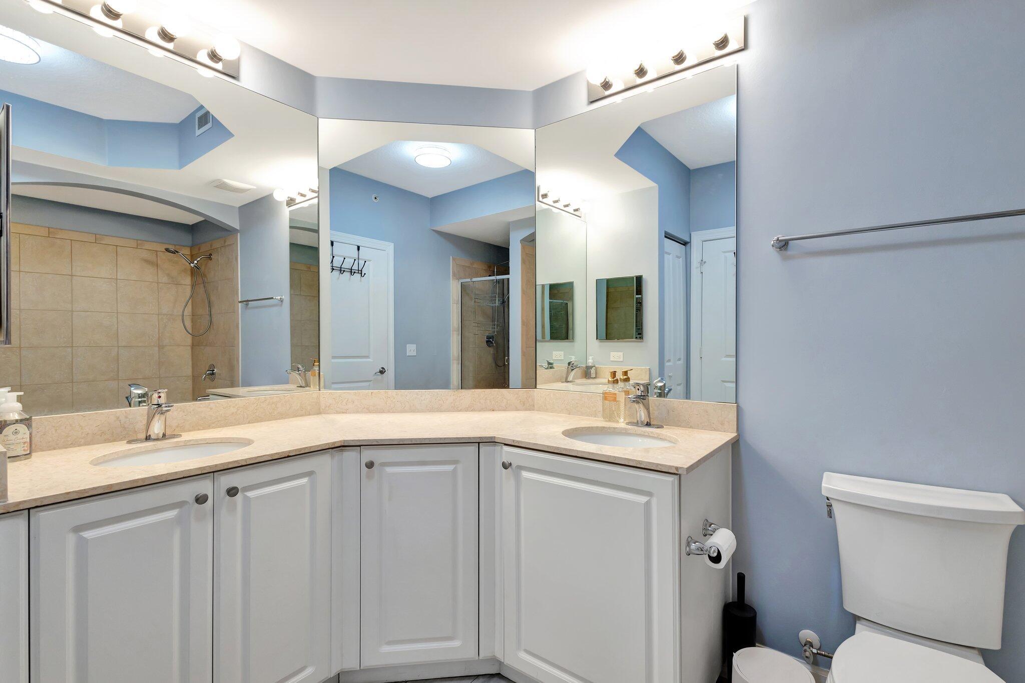 1690 Renaissance Commons Boulevard, Unit 1401 Boynton Beach, FL 33426 - Photo 16 of 41 a bathroom with a sink and a mirror