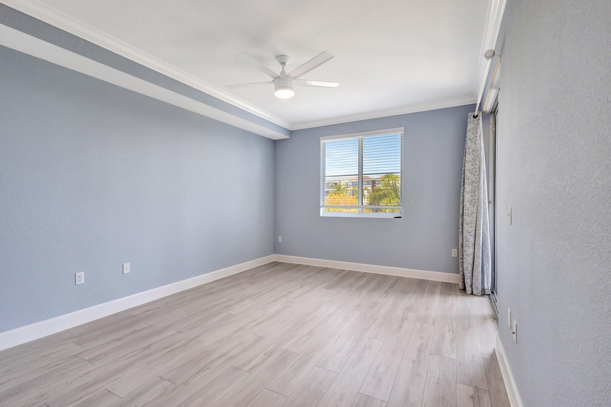1690 Renaissance Commons Boulevard, Unit 1401 Boynton Beach, FL 33426 - Photo 17 of 41 wooden floor in an empty room with a window