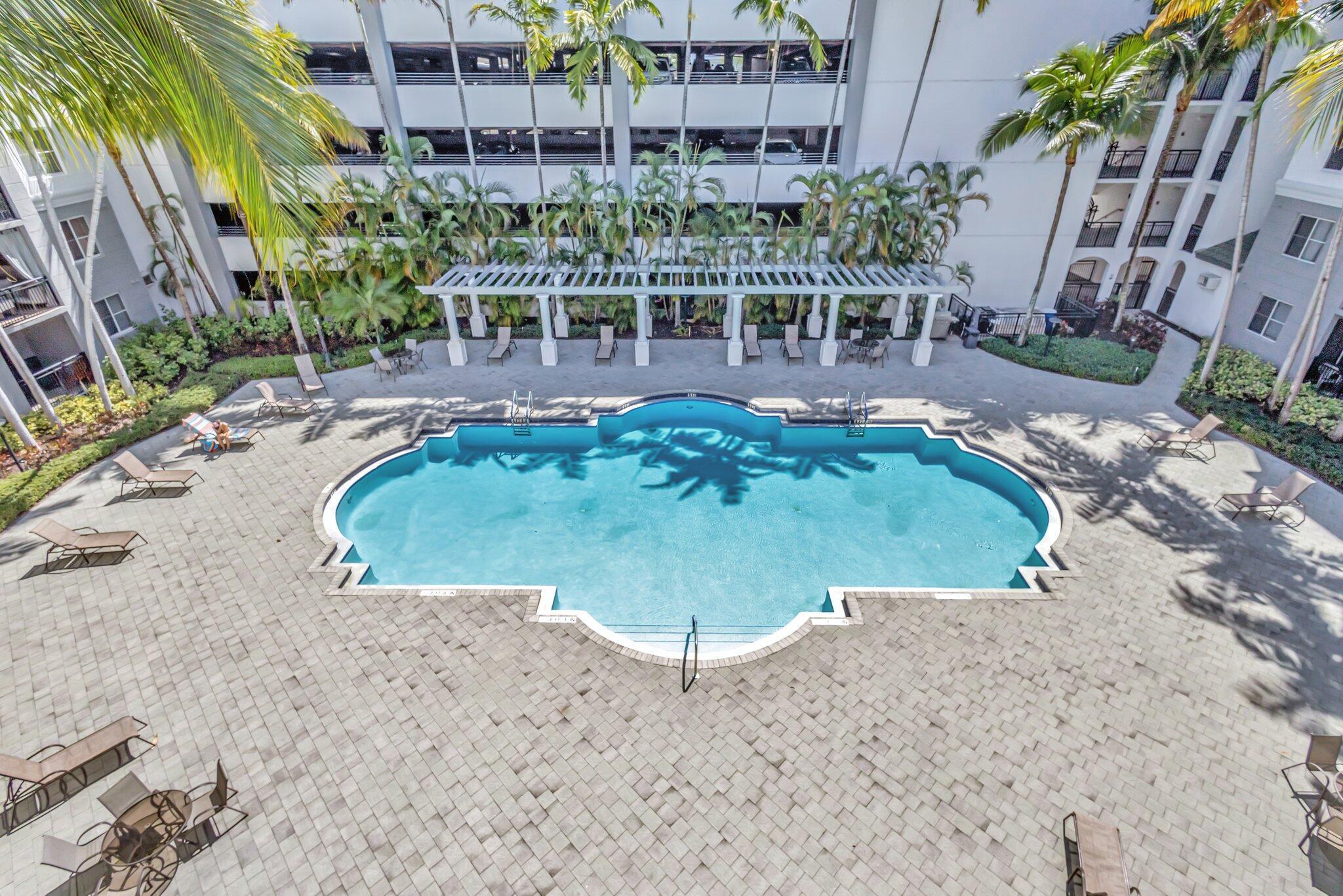 1690 Renaissance Commons Boulevard, Unit 1401 Boynton Beach, FL 33426 - Photo 2 of 41 a view of a swimming pool with sitting area