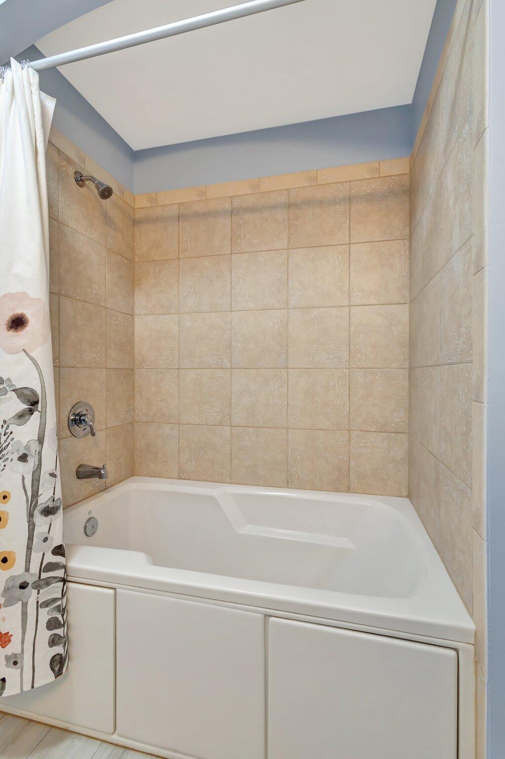 1690 Renaissance Commons Boulevard, Unit 1401 Boynton Beach, FL 33426 - Photo 24 of 41 a bathroom with a bathtub and a shower