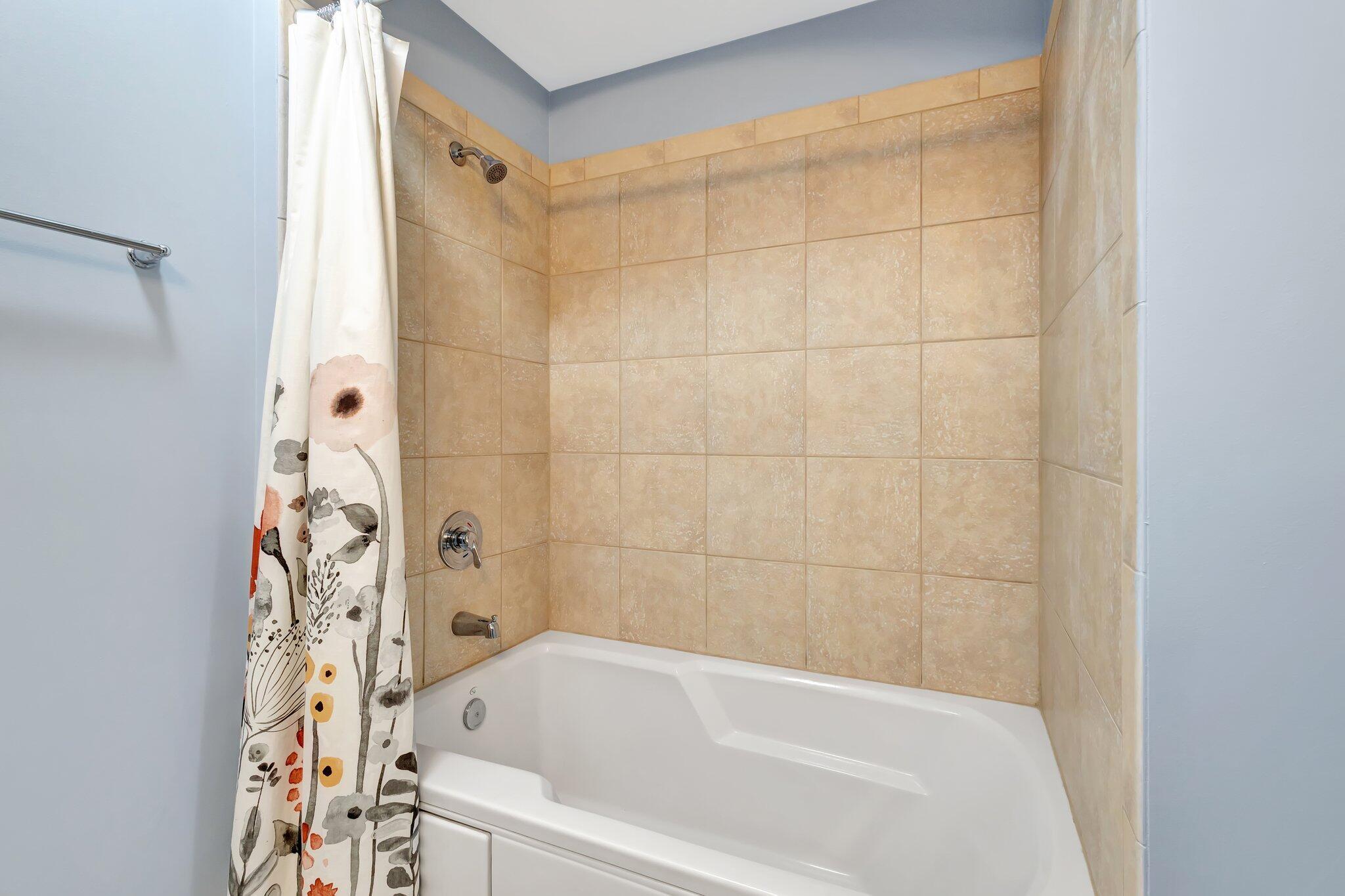 1690 Renaissance Commons Boulevard, Unit 1401 Boynton Beach, FL 33426 - Photo 25 of 41 a bathroom with a bathtub and shower