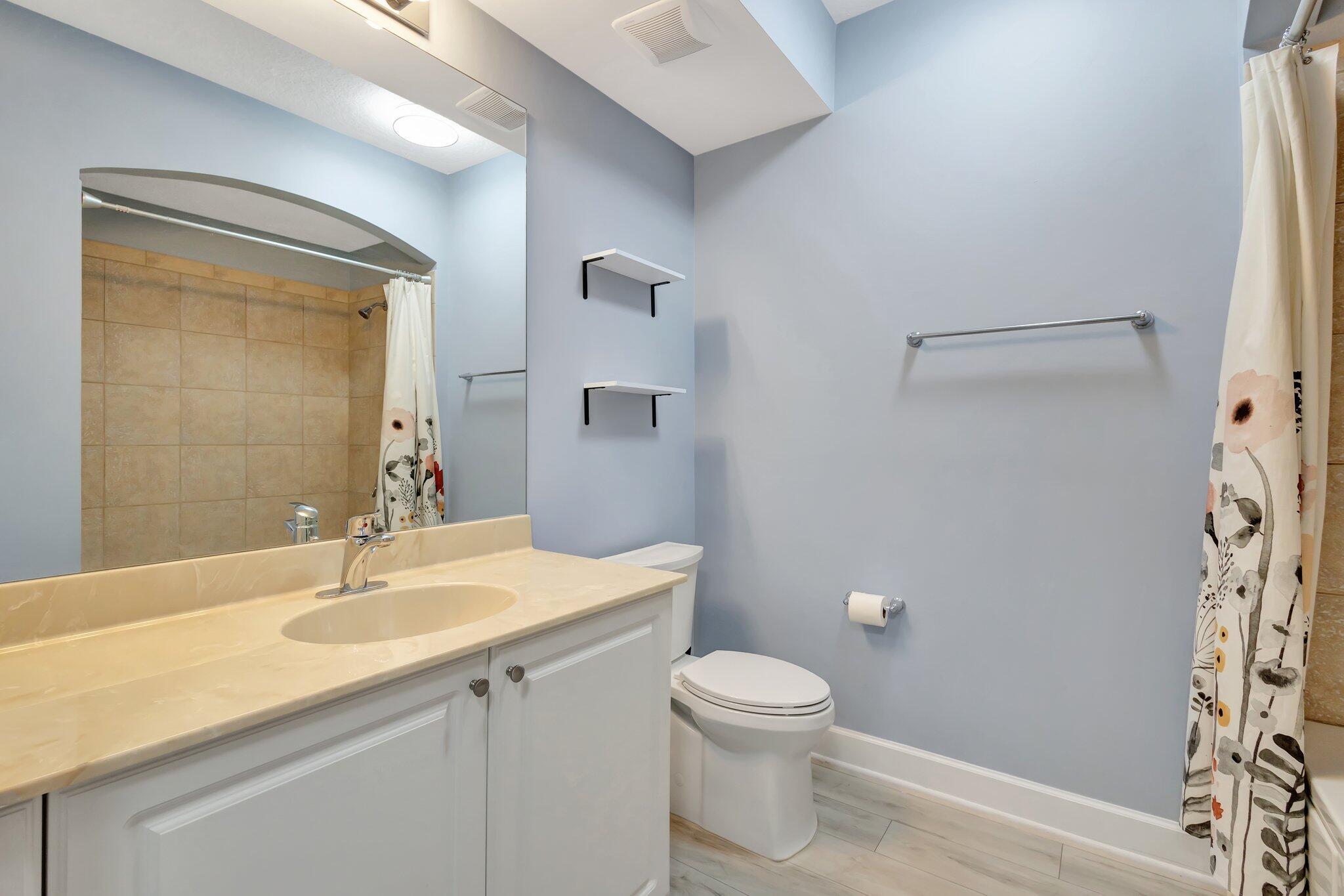 1690 Renaissance Commons Boulevard, Unit 1401 Boynton Beach, FL 33426 - Photo 27 of 41 a bathroom with a sink a toilet and shower