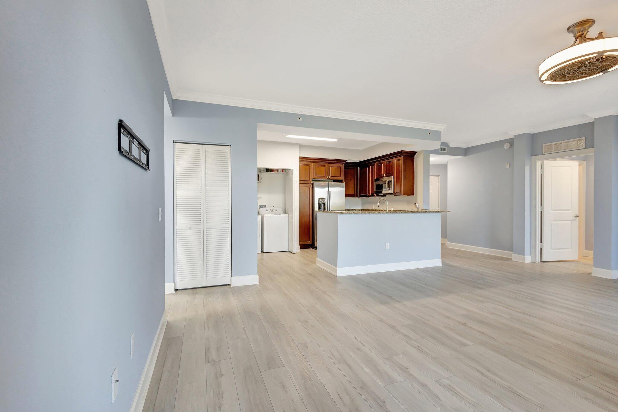 1690 Renaissance Commons Boulevard, Unit 1401 Boynton Beach, FL 33426 - Photo 32 of 41 a view of a kitchen with a sink and a refrigerator