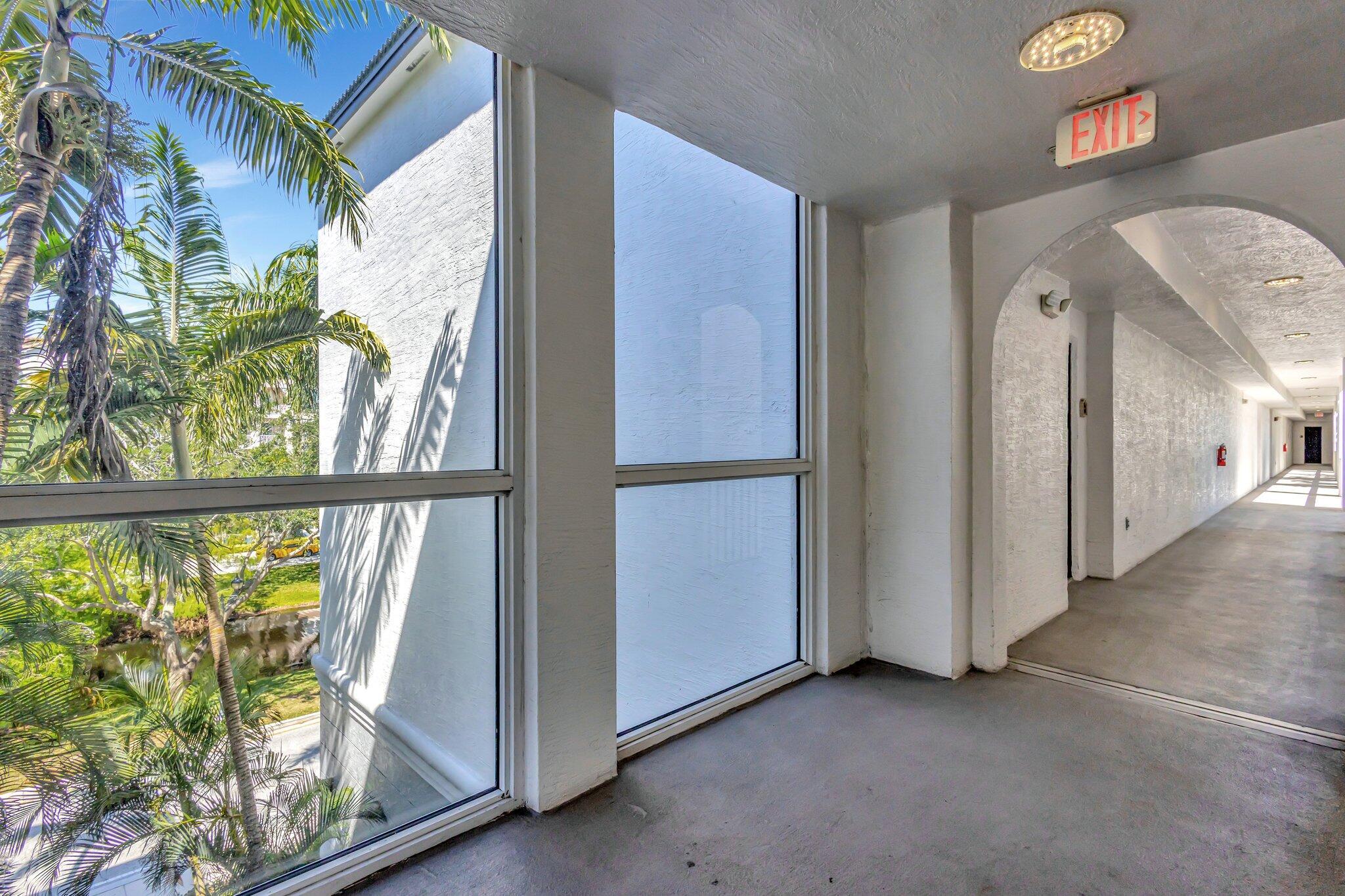 1690 Renaissance Commons Boulevard, Unit 1401 Boynton Beach, FL 33426 - Photo 35 of 41 an empty room with windows