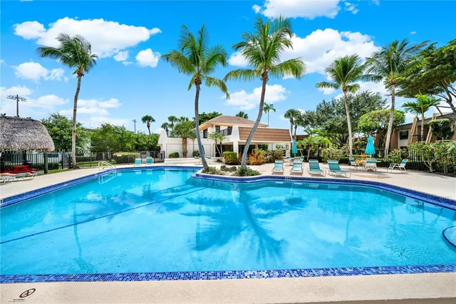 a front view of house with yard and swimming pool