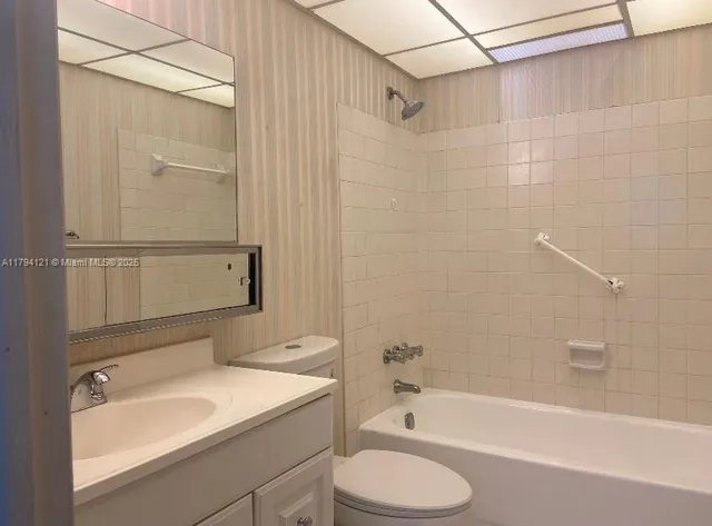 a bathroom with a sink a toilet and bathtub