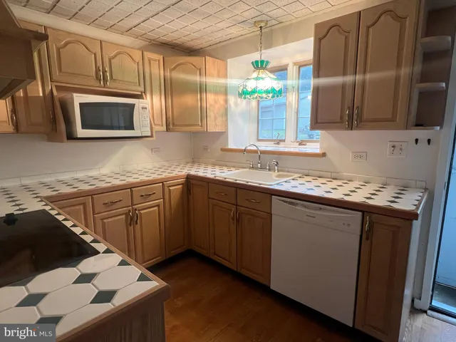 a kitchen with stainless steel appliances granite countertop a sink stove and microwave