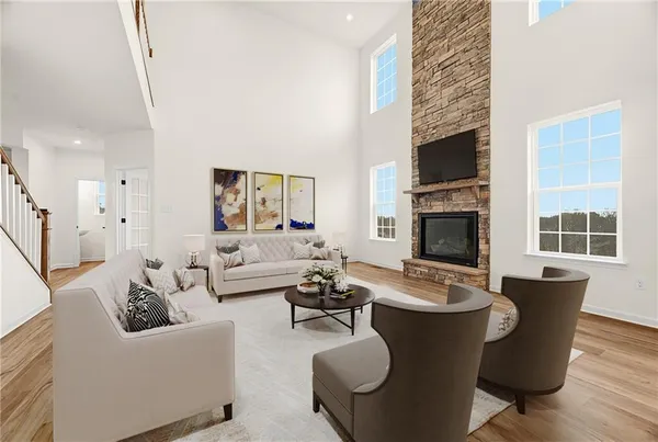 a living room with furniture a fireplace and a flat screen tv
