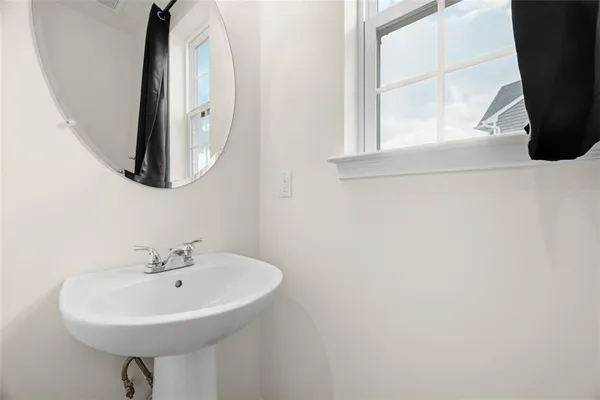 a bathroom with a sink a mirror and a window