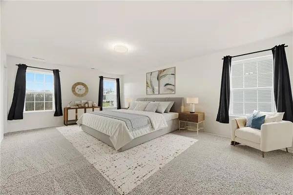 a spacious bedroom with a bed and a large window