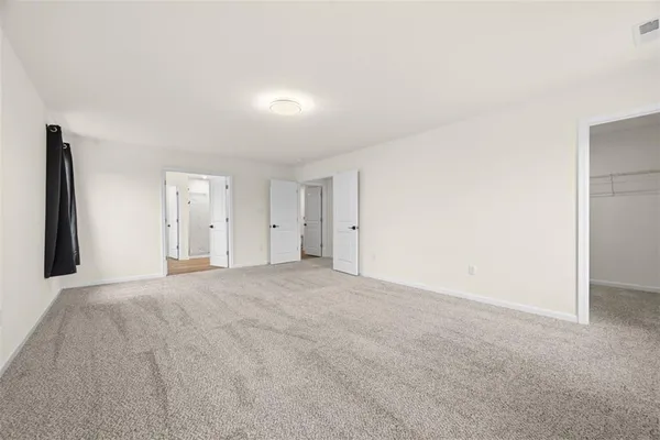 a view of an empty room with a closet