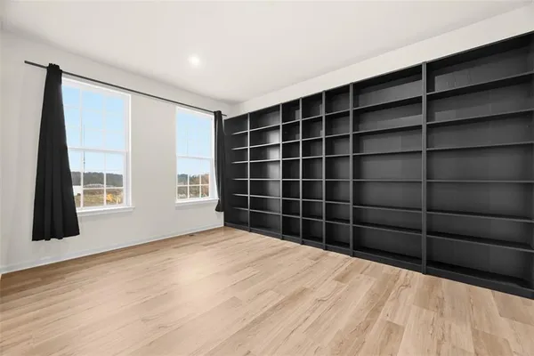 a view of a room with windows and cabinet