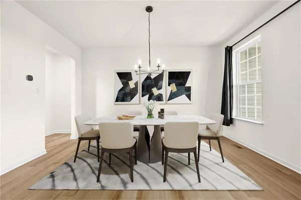 a view of a dining room with furniture window and wooden floor