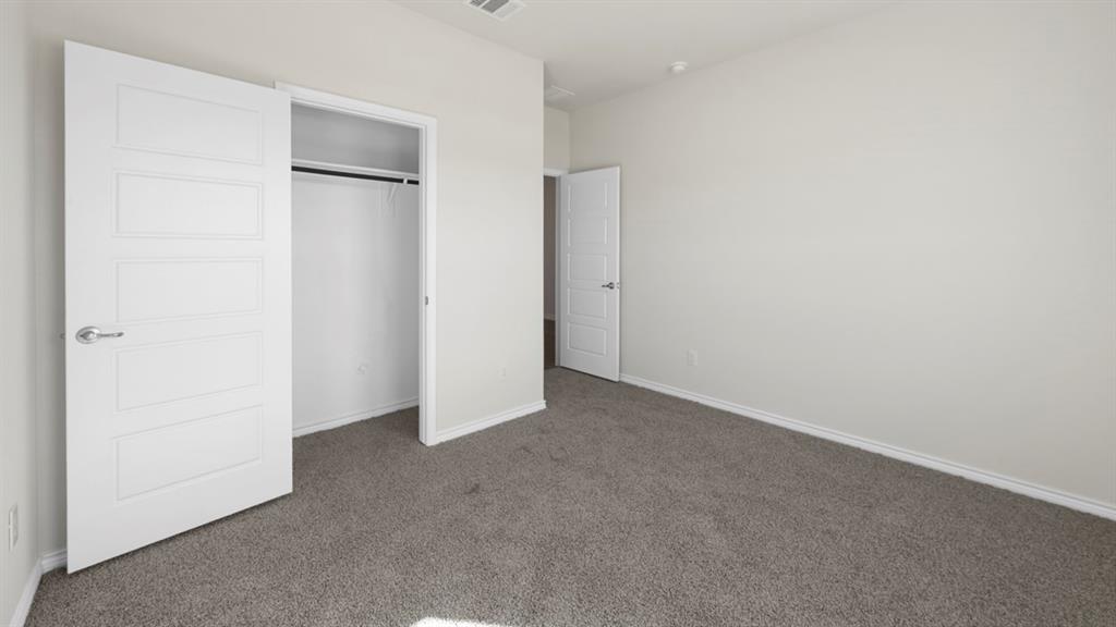 412 Carthage Street Caddo Mills, TX 75135 - Photo 6 of 32 Room featuring light gray carpet, white painted walls, and a white interior door with contemporary paneling