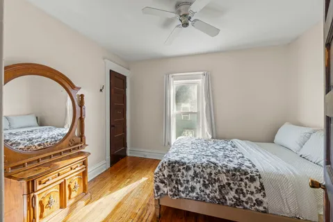 a bedroom with a bed and a chandelier