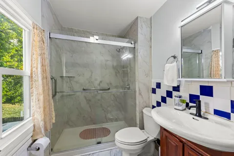a bathroom with a sink toilet and shower