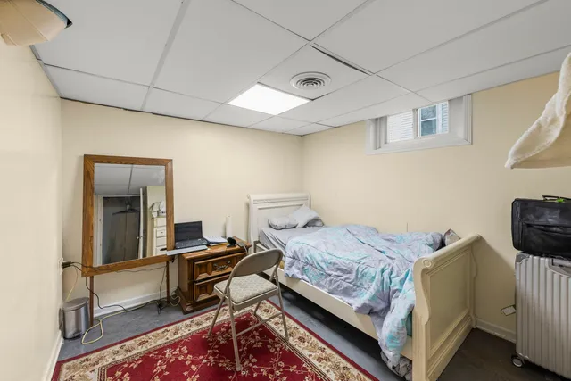 a bedroom with a bed and a dresser