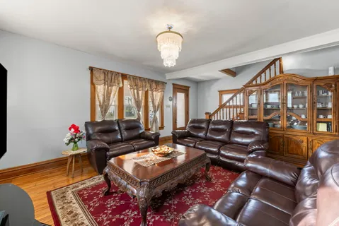 a living room with furniture a rug and a chandelier