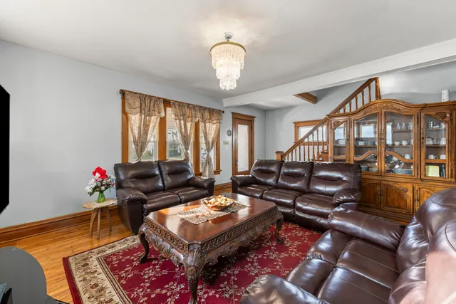 a living room with furniture a rug and a chandelier