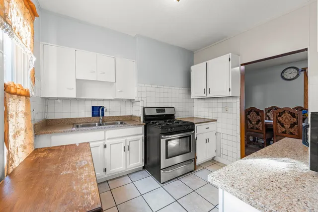 a kitchen with stainless steel appliances granite countertop a stove sink and cabinets