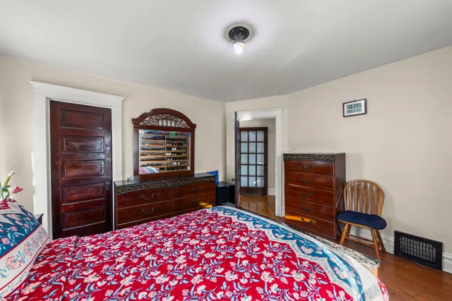 a bedroom with a bed and a dresser