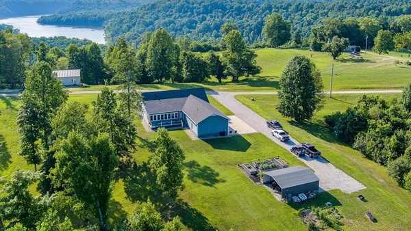 an aerial view of a house with a yard and swimming pool