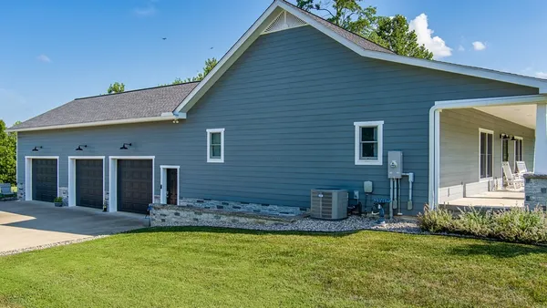 a front view of house with outdoor seating and yard