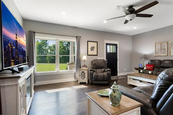 a living room with furniture and a flat screen tv