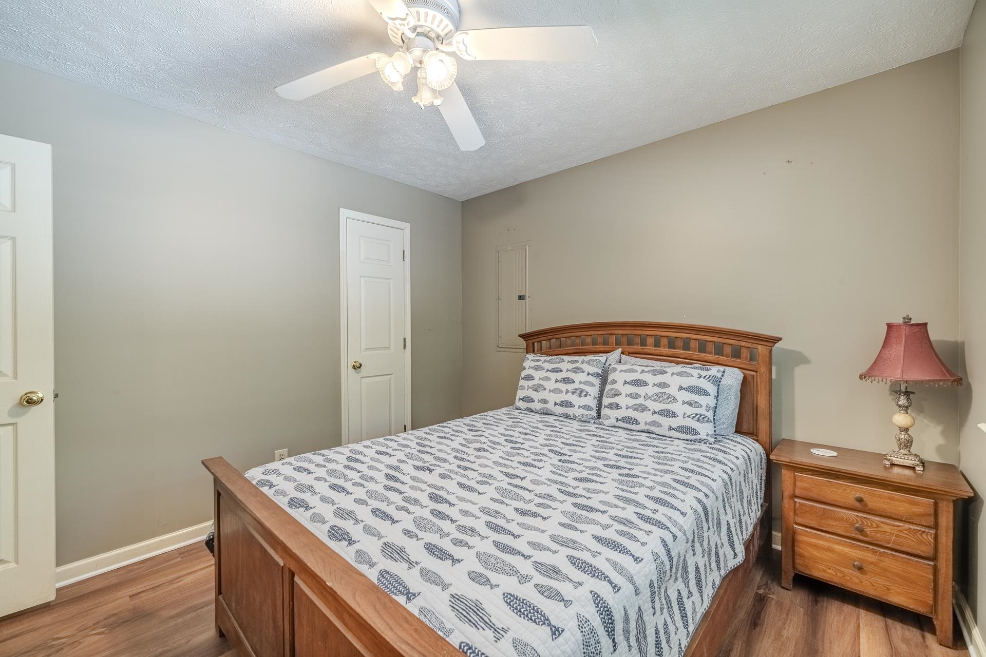 435 Murray Lane Counce, TN 38326 - Photo 19 of 34 Bedroom featuring wood-finish flooring, neutral wall tones, and a ceiling fan with integrated lighting