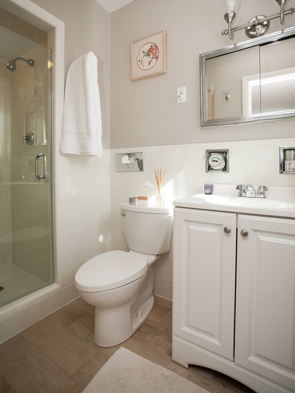 566 Newton Street Brookline, MA 02467 - Photo 16 of 30 a bathroom with a sink toilet and vanity