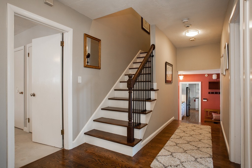 566 Newton Street Brookline, MA 02467 - Photo 19 of 30 a view of hallway with stairs and wooden floor