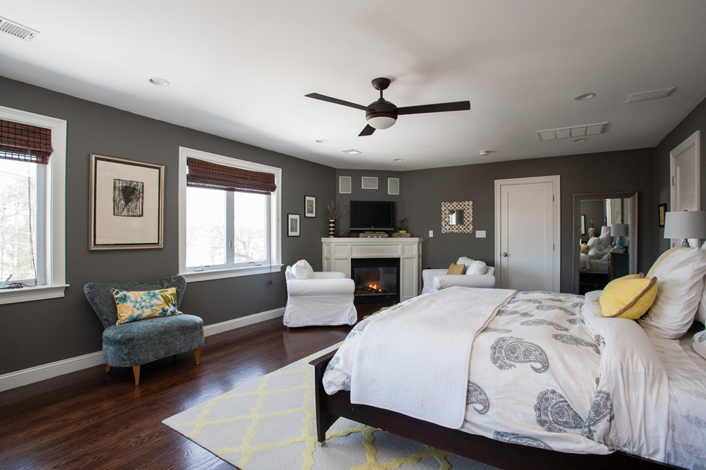 566 Newton Street Brookline, MA 02467 - Photo 21 of 30 a bedroom with a bed couch and windows