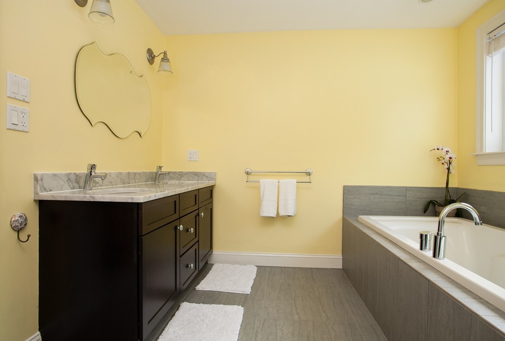 566 Newton Street Brookline, MA 02467 - Photo 23 of 30 a bathroom with a sink and a mirror