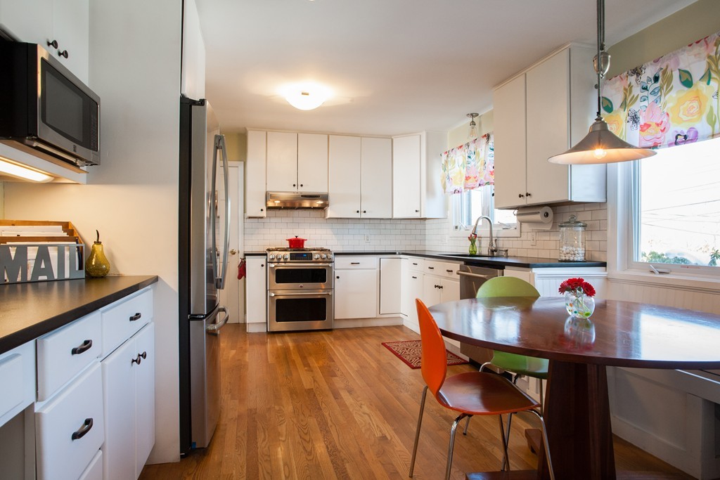 566 Newton Street Brookline, MA 02467 - Photo 9 of 30 a kitchen with stainless steel appliances a stove a sink and a refrigerator