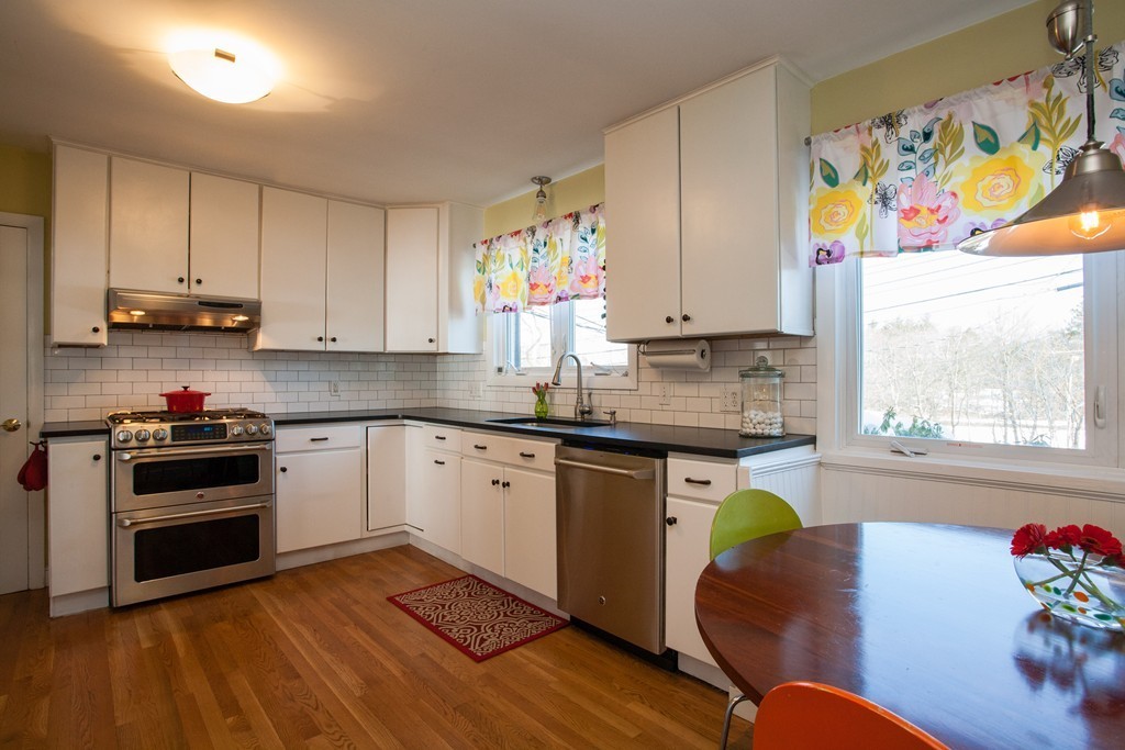 566 Newton Street Brookline, MA 02467 - Photo 10 of 30 a kitchen with stainless steel appliances granite countertop a stove a sink and a microwave