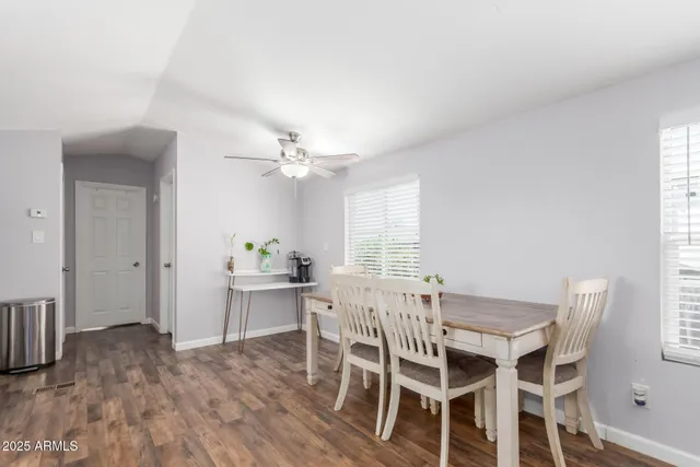 a view of a dining room with furniture and wooden floor